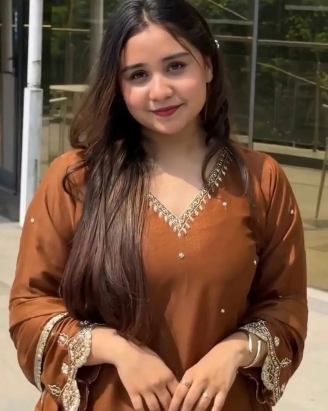 Woman wearing a brown sharara dress showing design