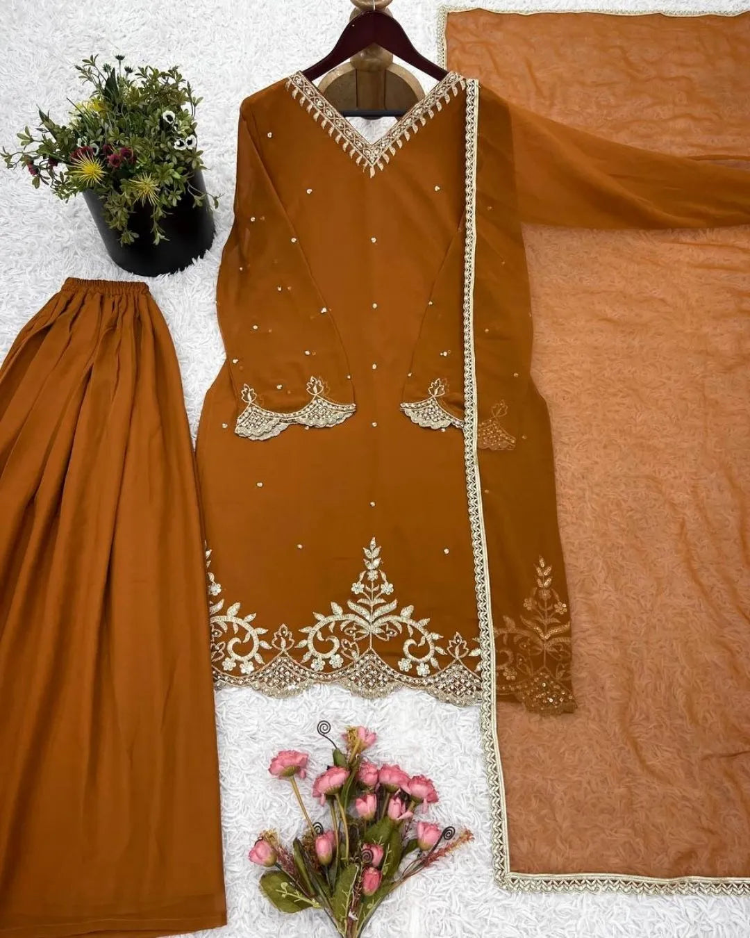 Brown traditional outfit with white embroidery on a white background