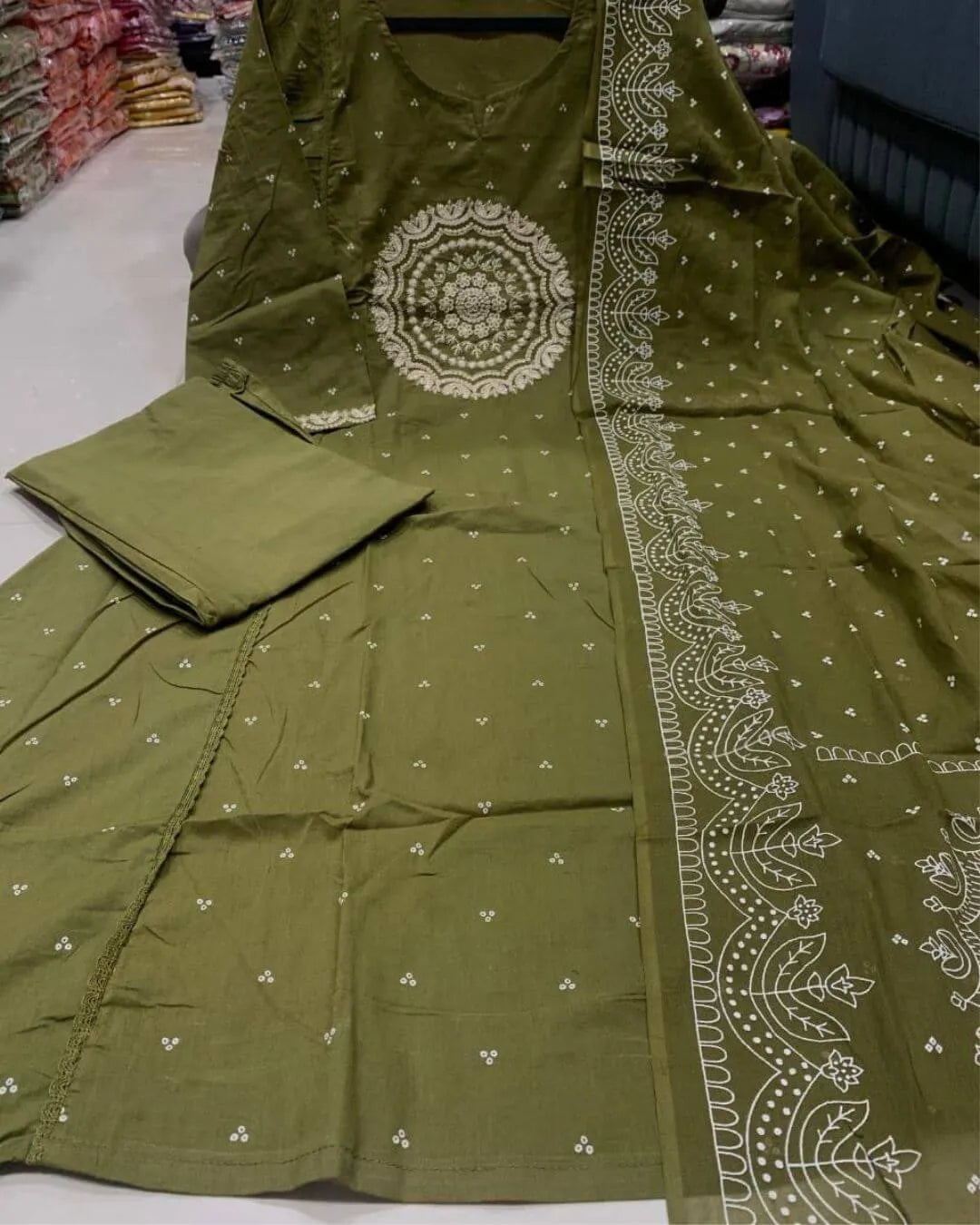 Woman wearing a green cotton kurti pant dupatta set traditional outfit