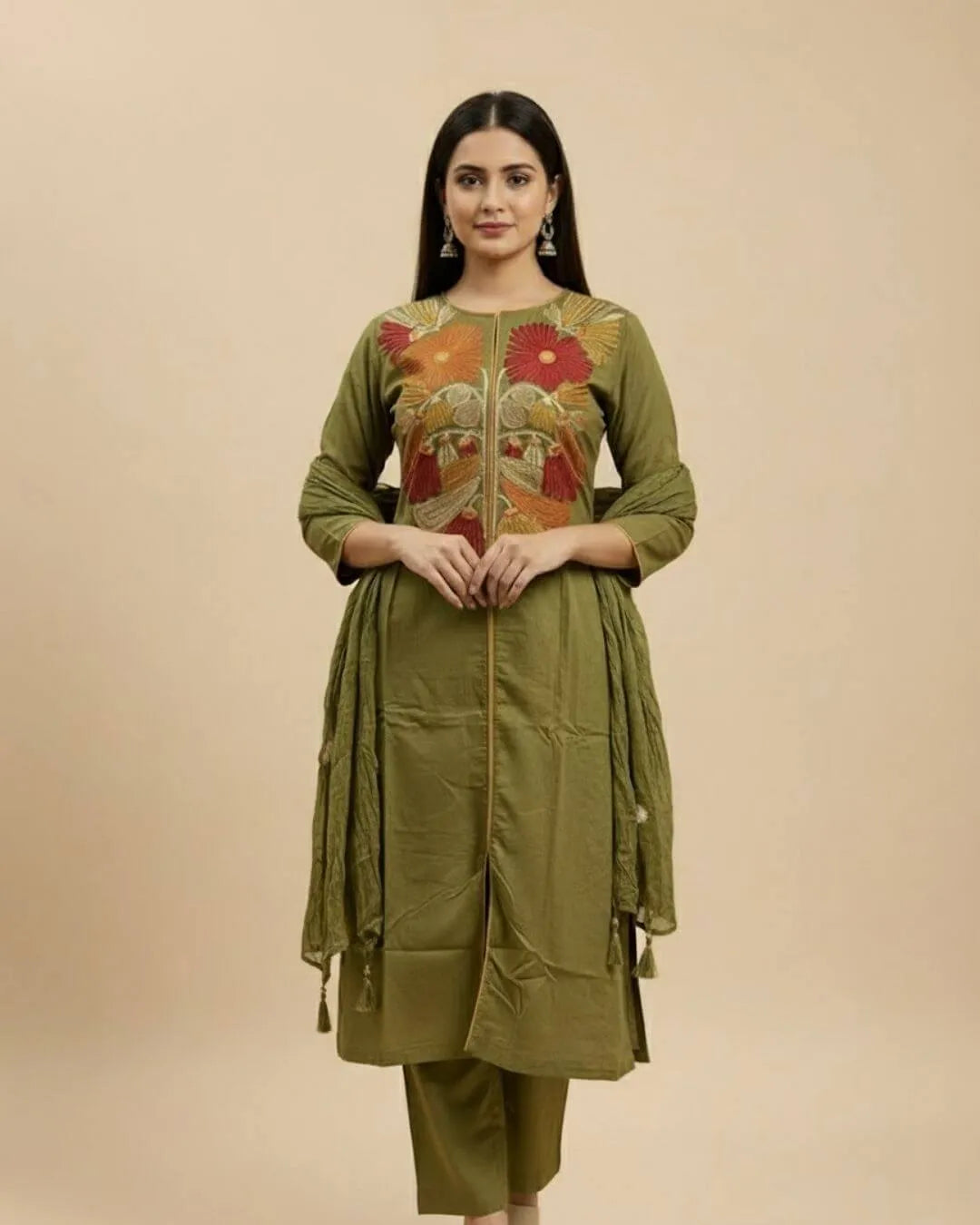 Woman wearing a Floral Printed Green Cotton Suit Set traditional outfit with floral patterns on a beige background