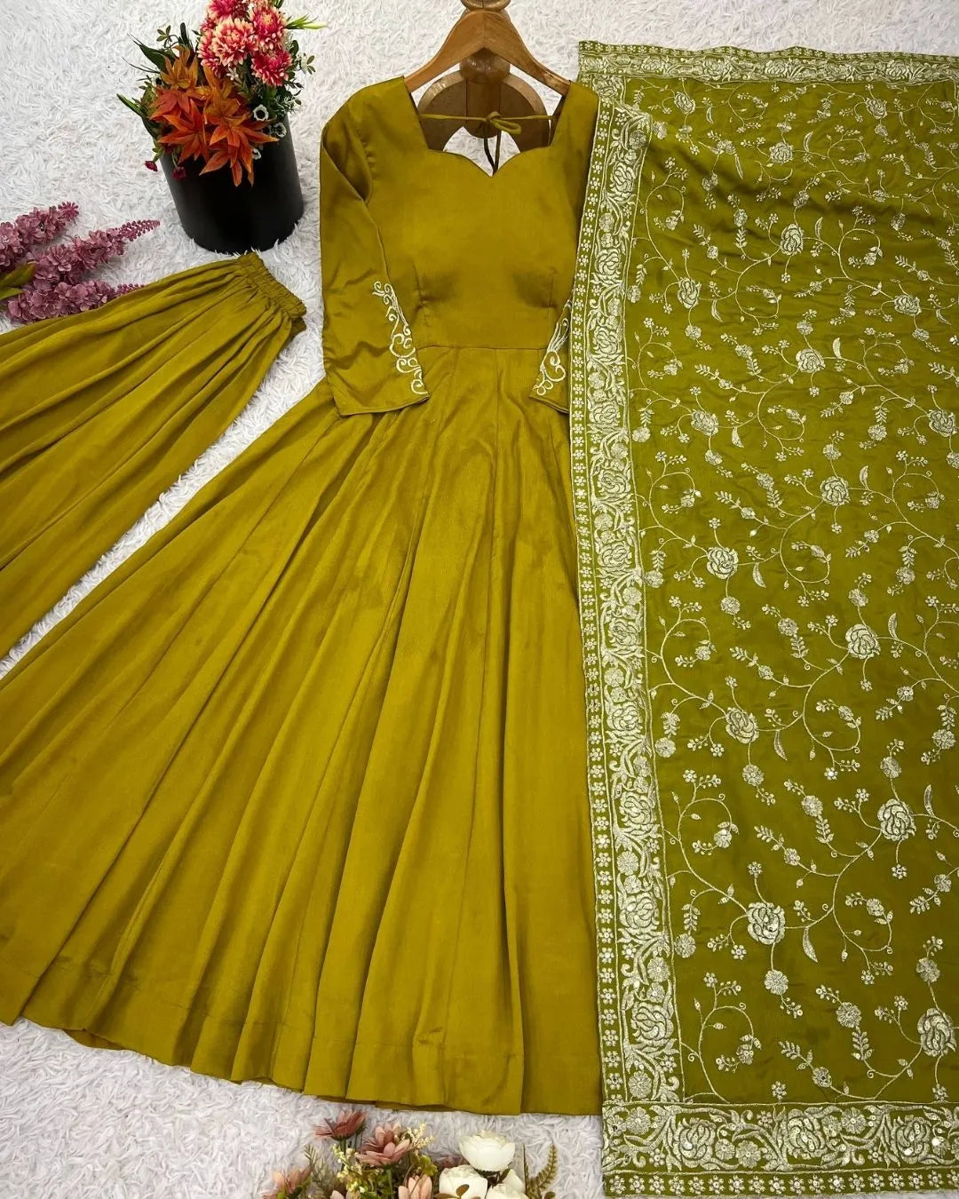 Green chiffon suit with floral border on a white background