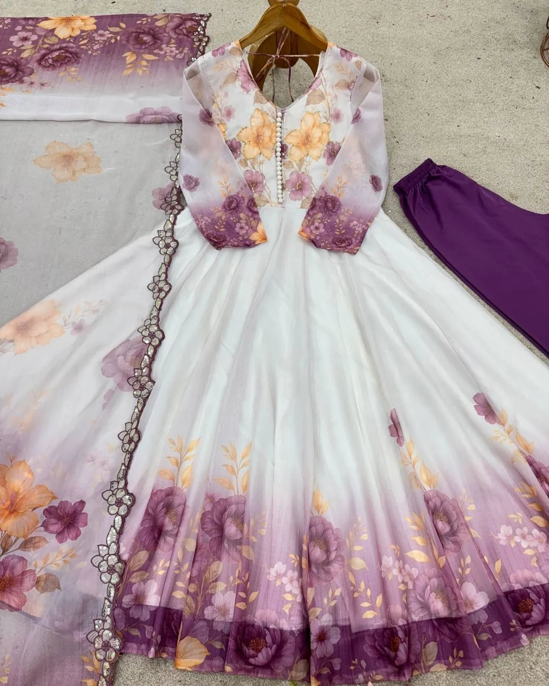 Floral dress with purple and yellow flowers on a plain background