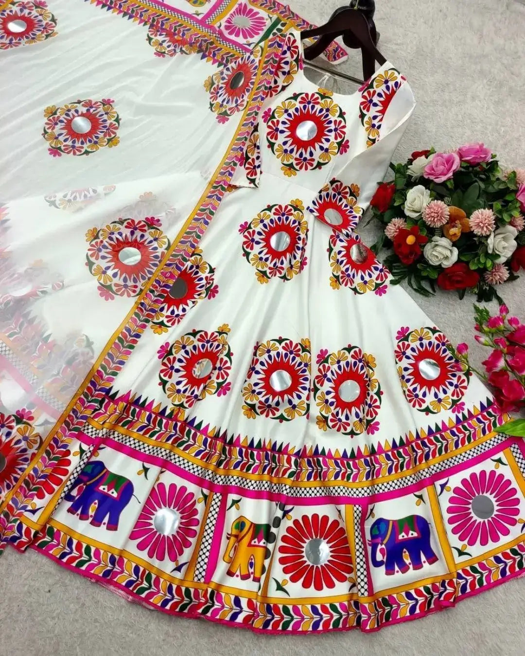 Colorful traditional outfit with floral and elephant patterns on a white background