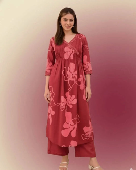 Woman wearing a Printed Cotton Anarkali Suit With Dupatta against a gradient background