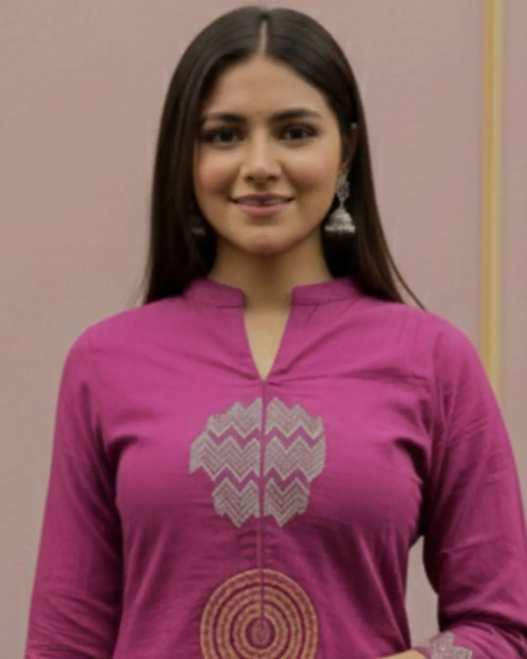 Woman wearing a Pink Cotton Suit With Dupatta Set outfit with a matching dupatta against a striped wall.