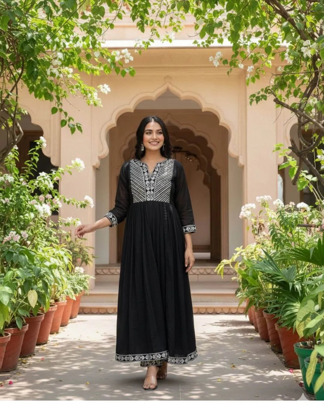 Woman in a Black Cotton Kurti Pant Dupatta Set traditional outfit with a flowing dupatta in a garden setting