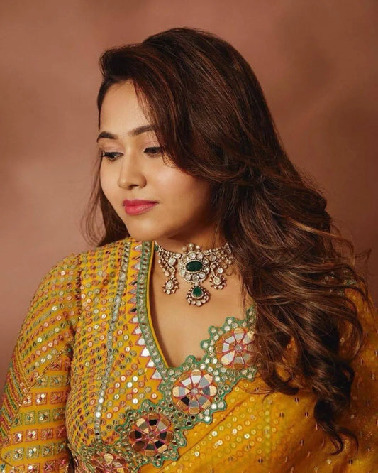 Woman wearing a mustard yellow embroidered saree