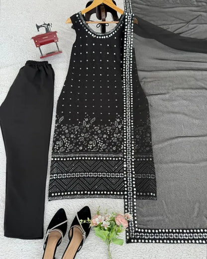 Black and white patterned dress with matching pants on a bed