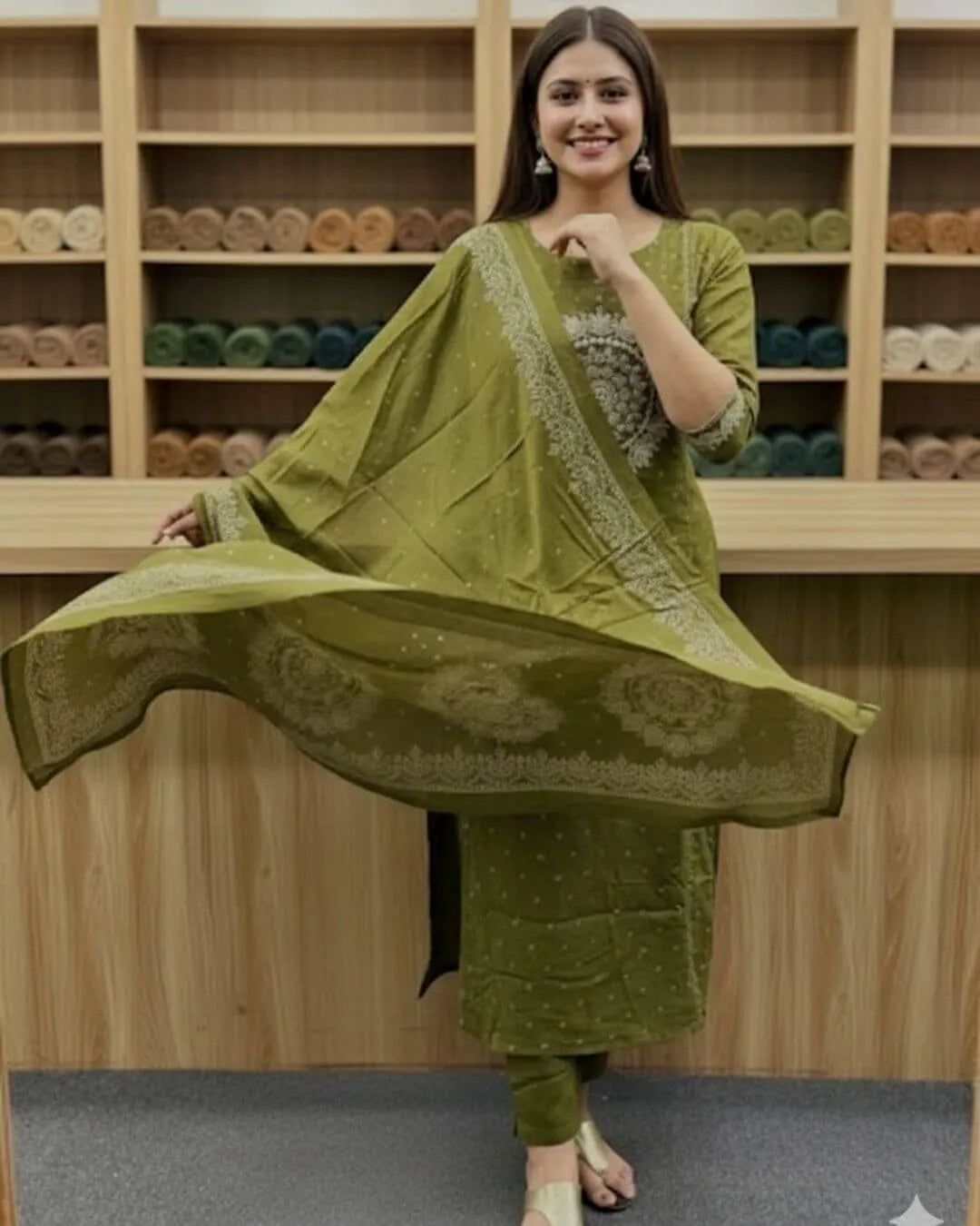 Woman in a Woman wearing a green cotton kurti pant dupatta set traditional outfit  traditional outfit with a matching dupatta in a store setting