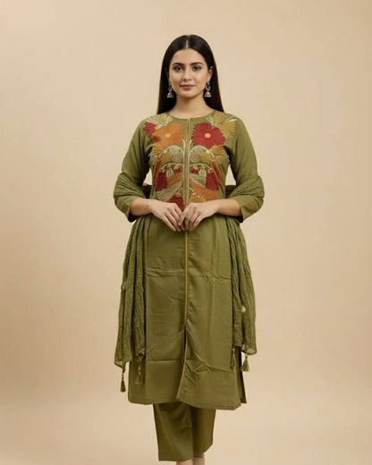Woman wearing a Floral Printed Green Cotton Suit Set traditional outfit with floral patterns on a beige background