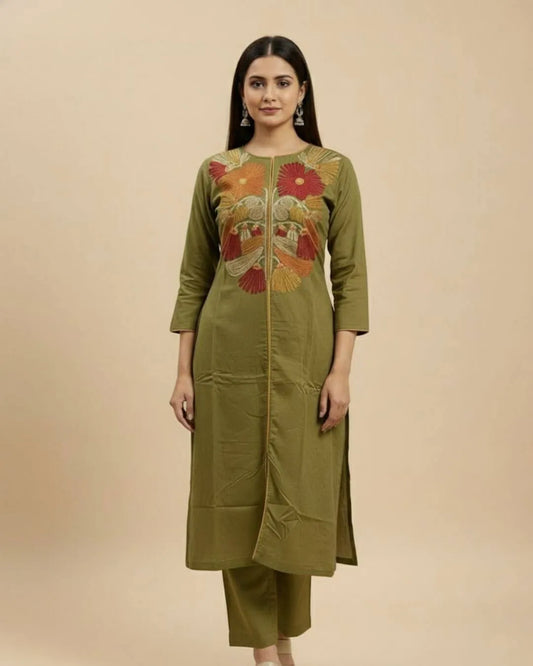 Woman wearing a Floral Printed Green Cotton Suit Set traditional outfit with floral patterns on a beige background