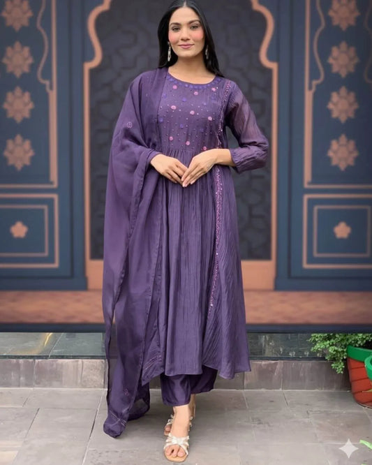 Woman wearing a Dark Purple Anarkali Dress With Dupatta Set outfit with a decorative background