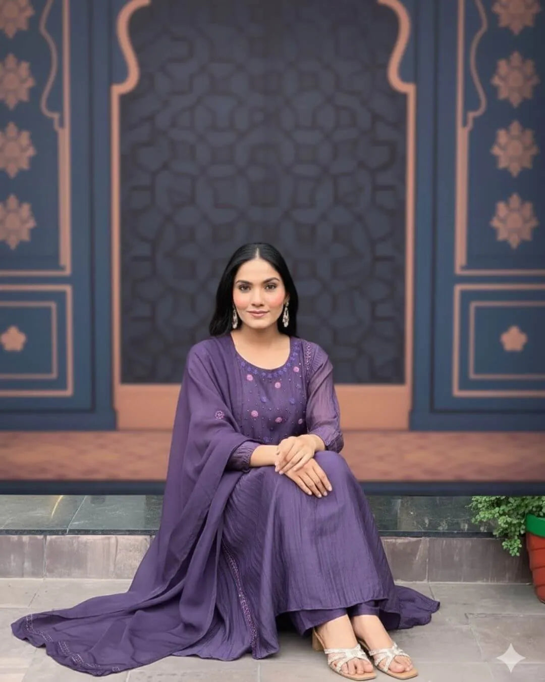 Woman wearing a Dark Purple Anarkali Dress With Dupatta Set outfit with a decorative background