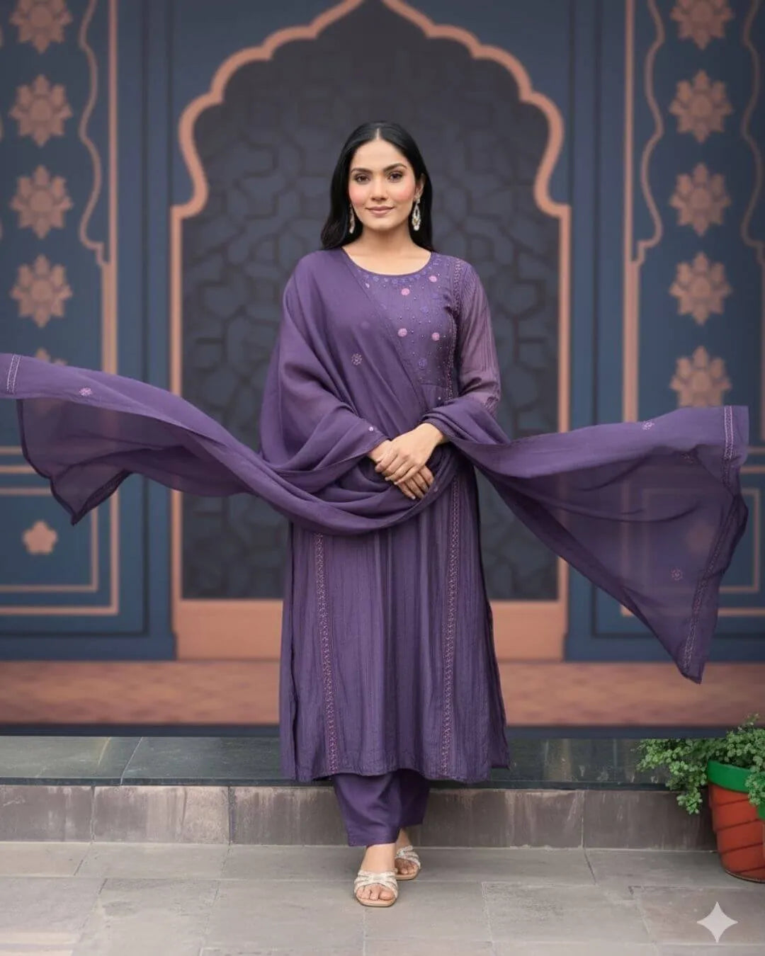 Woman wearing a Dark Purple Anarkali Dress With Dupatta Set outfit with a decorative background