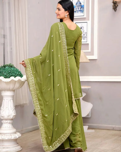 Woman wearing a green saree with a white background