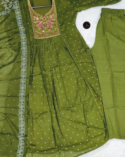 Green traditional outfit with embroidered top and matching pants on a white background