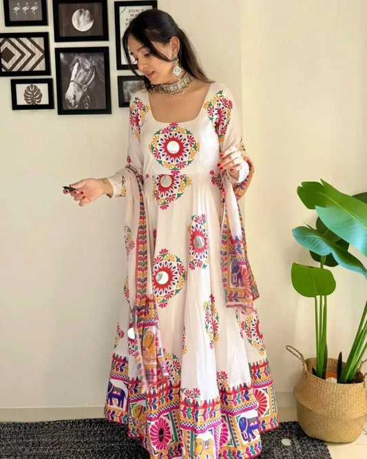 Woman wearing a colorful traditional outfit with a plant in the background