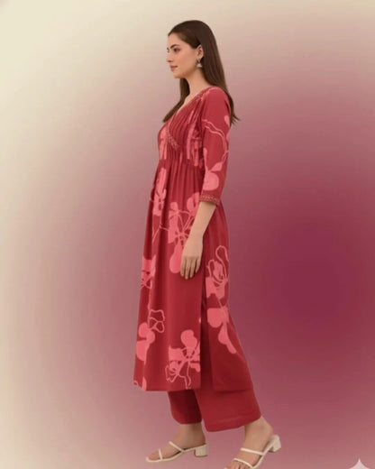 Woman wearing a Printed Cotton Anarkali Suit With Dupatta against a gradient background