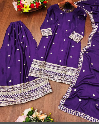 Purple traditional outfit with white patterns on a wooden surface