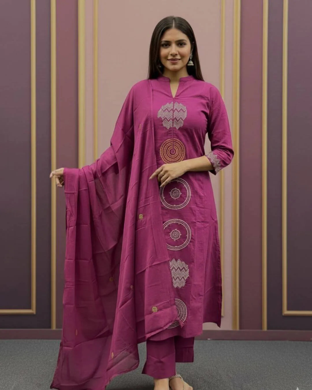 Woman wearing a Pink Cotton Suit With Dupatta Set outfit with a matching dupatta against a striped wall.