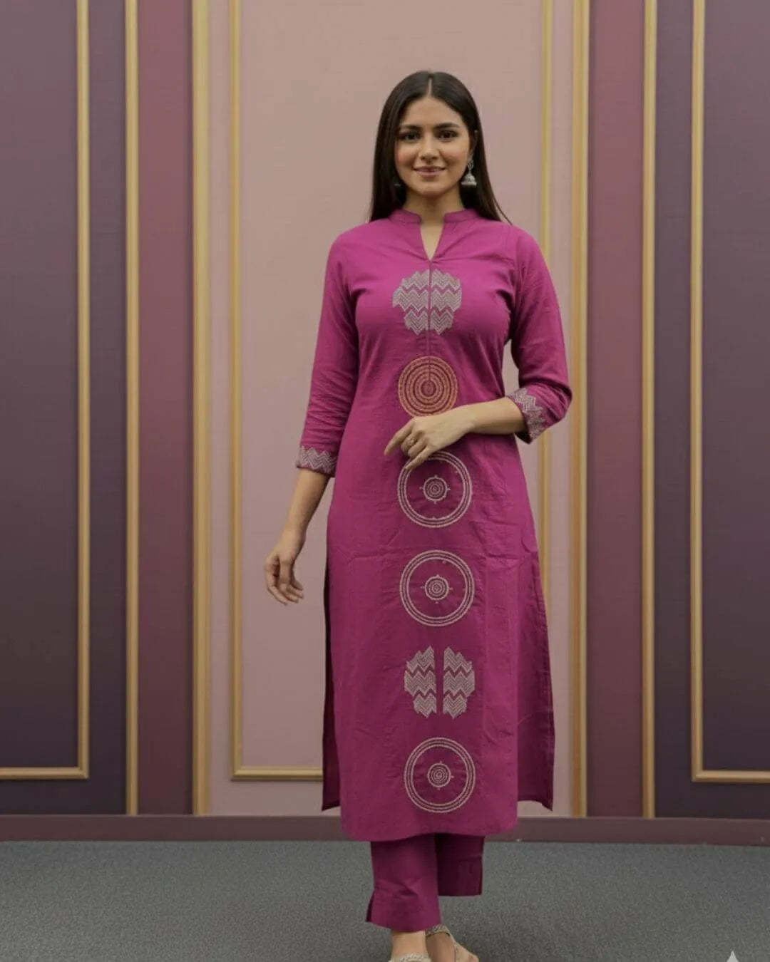 Woman wearing a Pink Cotton Suit With Dupatta Set outfit with a matching dupatta against a striped wall.