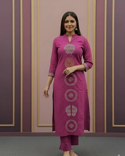 Woman wearing a Pink Cotton Suit With Dupatta Set outfit with a matching dupatta against a striped wall.