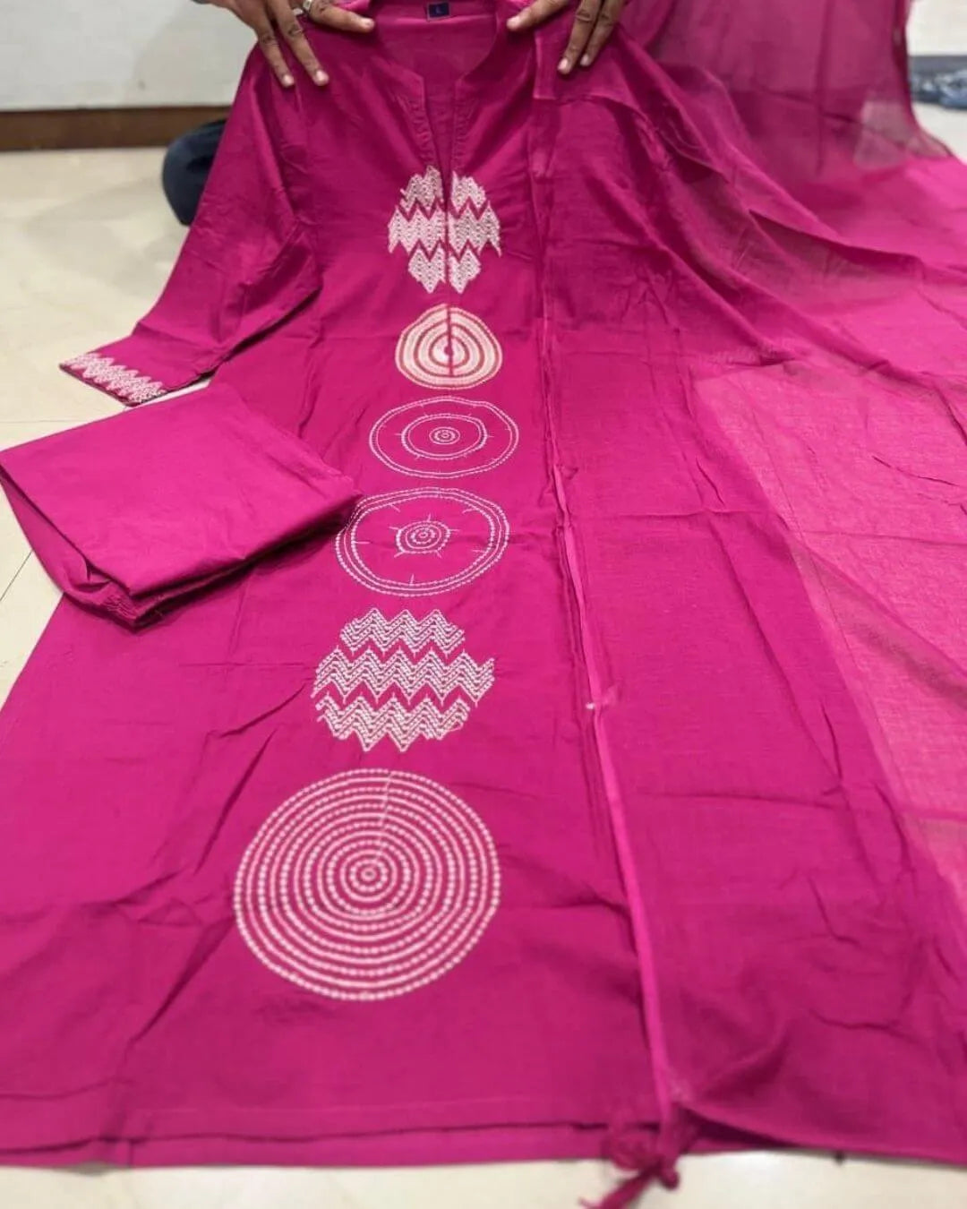 Woman wearing a Pink Cotton Suit With Dupatta Set outfit with a matching dupatta against a striped wall.
