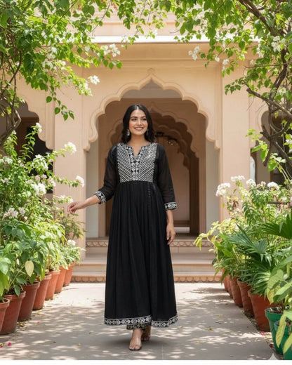 Woman in a Black Cotton Kurti Pant Dupatta Set traditional outfit with a flowing dupatta in a garden setting