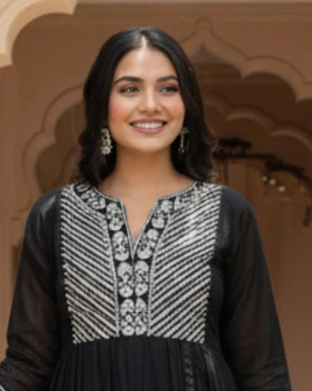 Woman in a Black Cotton Kurti Pant Dupatta Set traditional outfit with a flowing dupatta in a garden setting