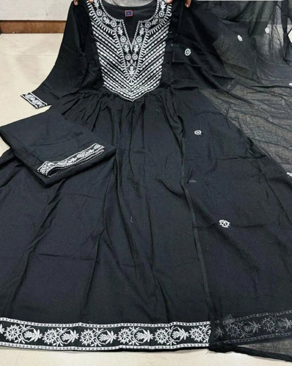 Woman in a Black Cotton Kurti Pant Dupatta Set traditional outfit with a flowing dupatta in a garden setting