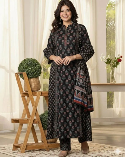 Woman wearing a black Anarkali kurti pant dupatta set standing in a bright room