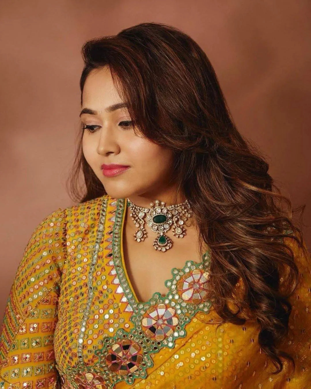 Woman wearing a mustard yellow embroidered saree 